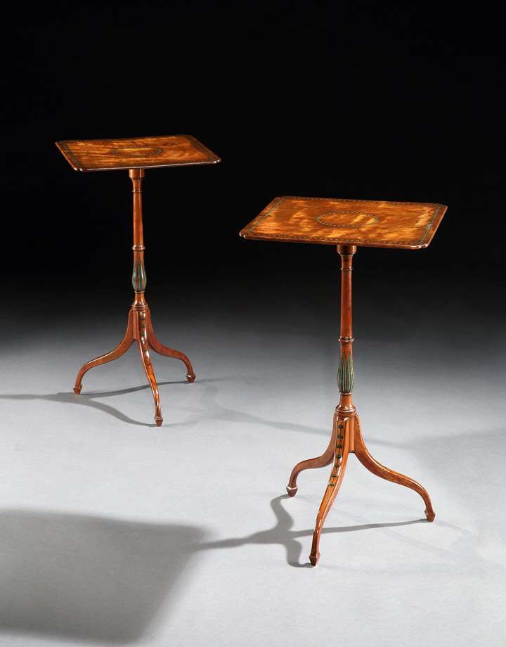 A pair of George III polychrome decorated satinwood tripod tables
